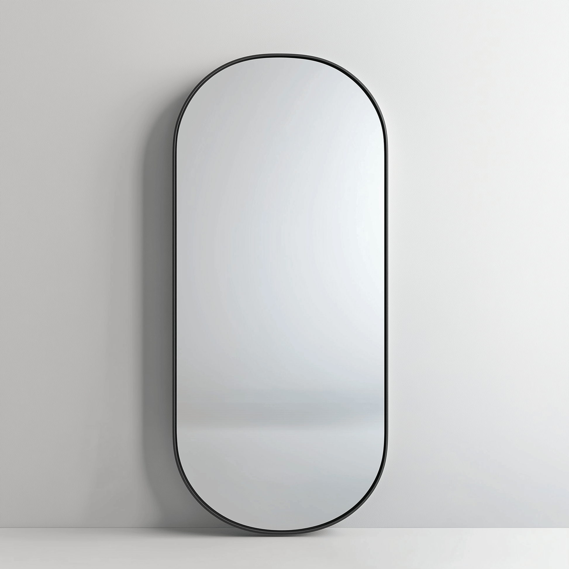 Pill 80 x 45 Duo mirror with black aluminium frame mounted on a white wall, showcasing its clean and durable design.