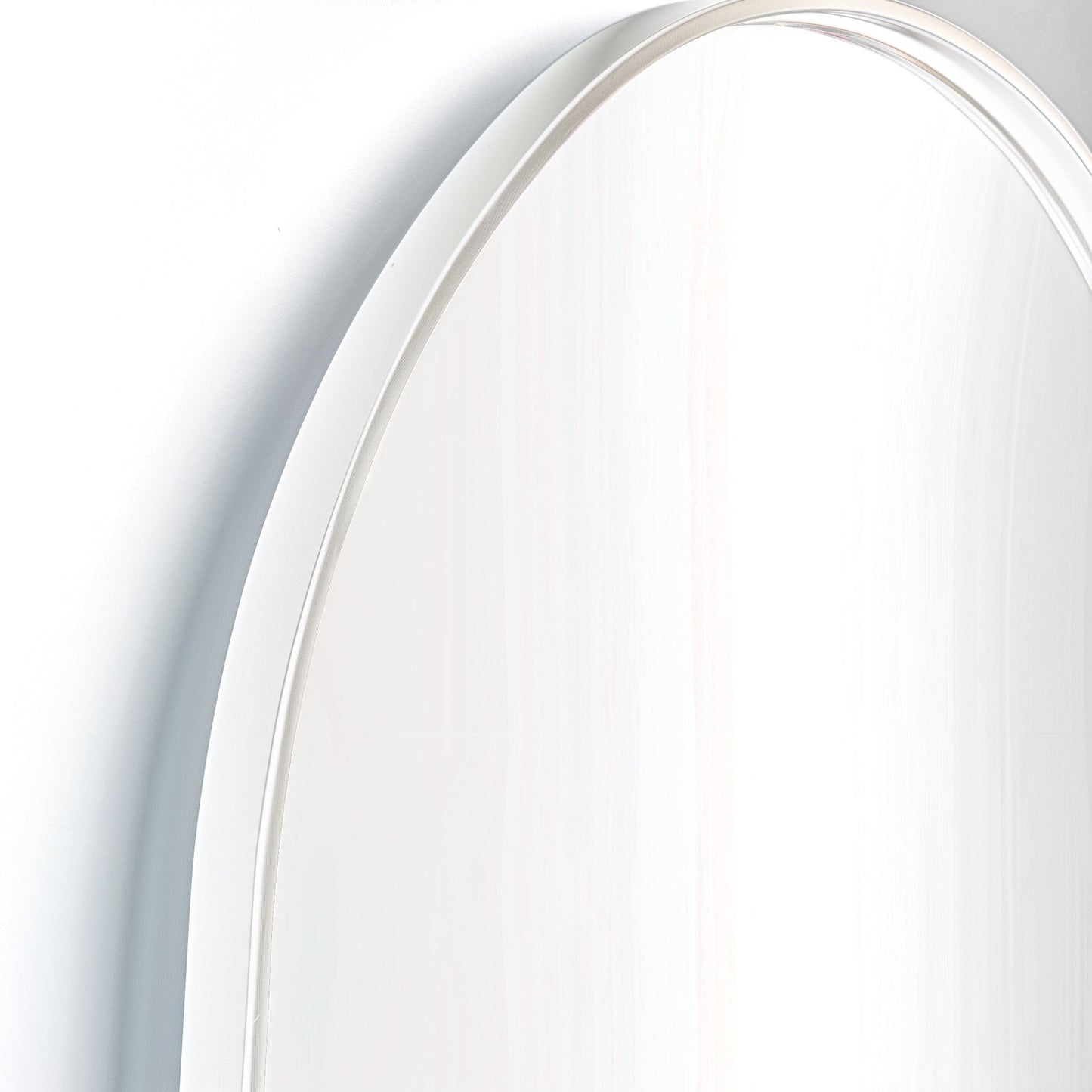 Close-up of white-framed Arch Aluminium Mirror 60x90. Smooth curve and clean lines reflect minimalist design ethos.