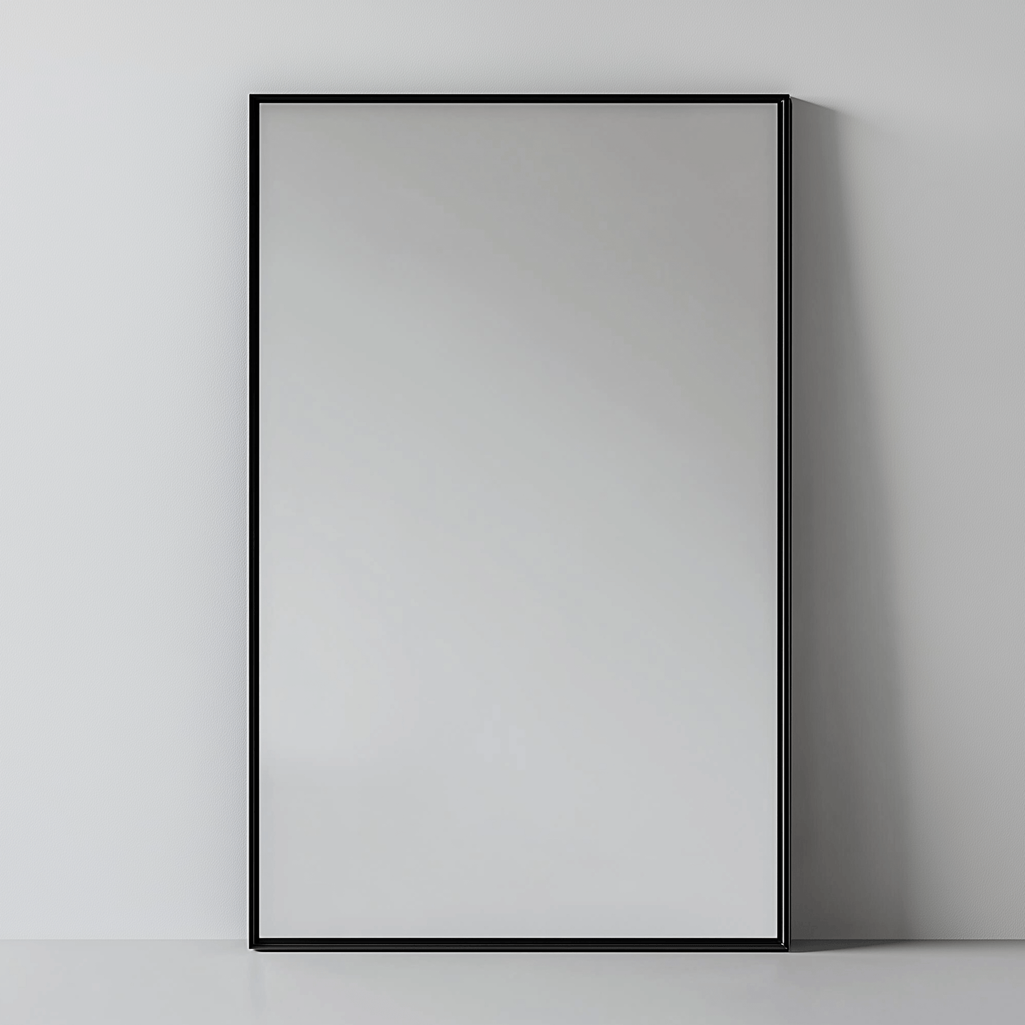 Rectangular Aluminium Mirror - Wall Mirror | 60x90 cm, Thin Frame in matte black finish, leaning against a neutral wall for versatile styling.