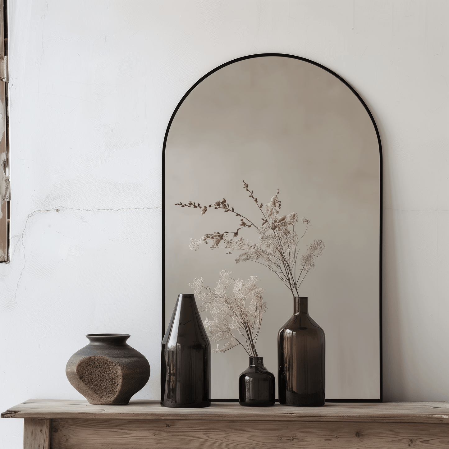 Arch Aluminium Mirror 60x90 styled on wooden console with vases. Enhances natural light and adds elegance to any interior space.
