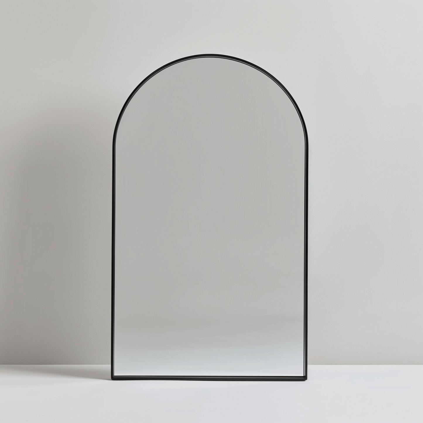 Freestanding Arch Aluminium Mirror 60x90 with black frame. Ideal for entryways or bedrooms in minimalist home settings.
