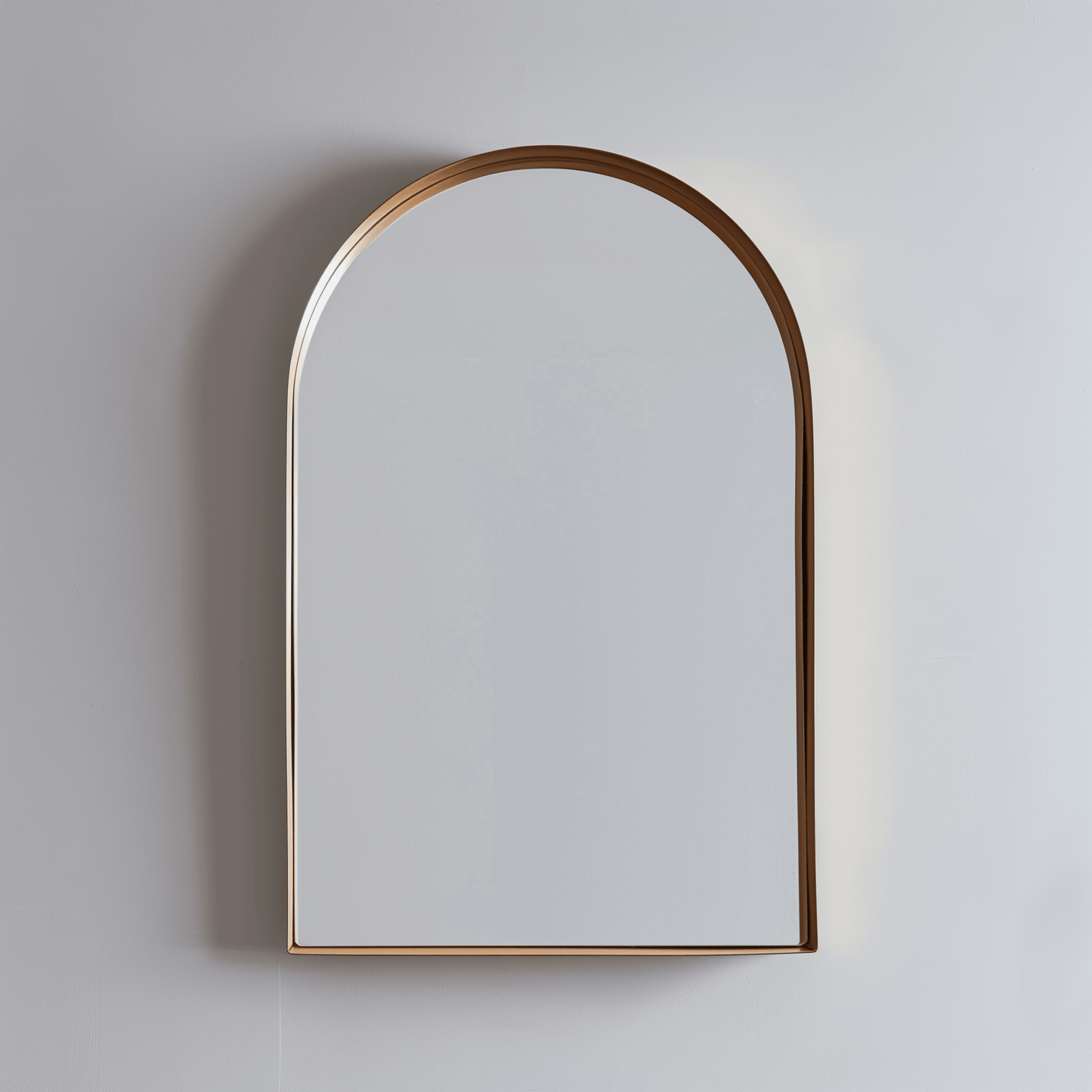 Wall-mounted Arch Aluminium Mirror 60x90 with rose gold frame. Adds a warm metallic accent to modern interiors.
