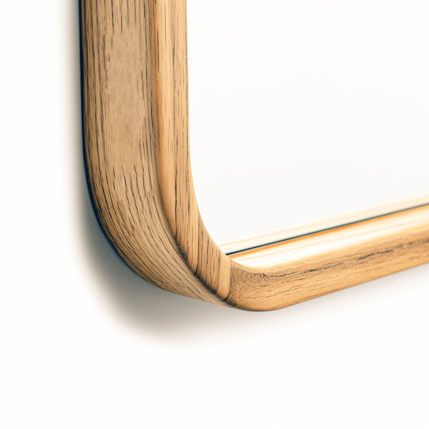 Detailed corner view of the handcrafted African Walnut frame on a 60 x 90 cm rounded rectangle mirror, highlighting wood texture.