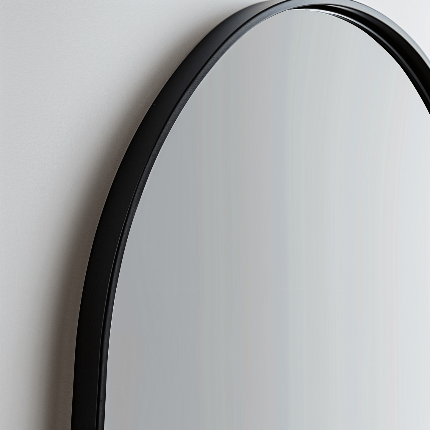Close-up of black-framed Arch 70 x 55cm Duo mirror, emphasizing the smooth curve and sleek aluminium edge.