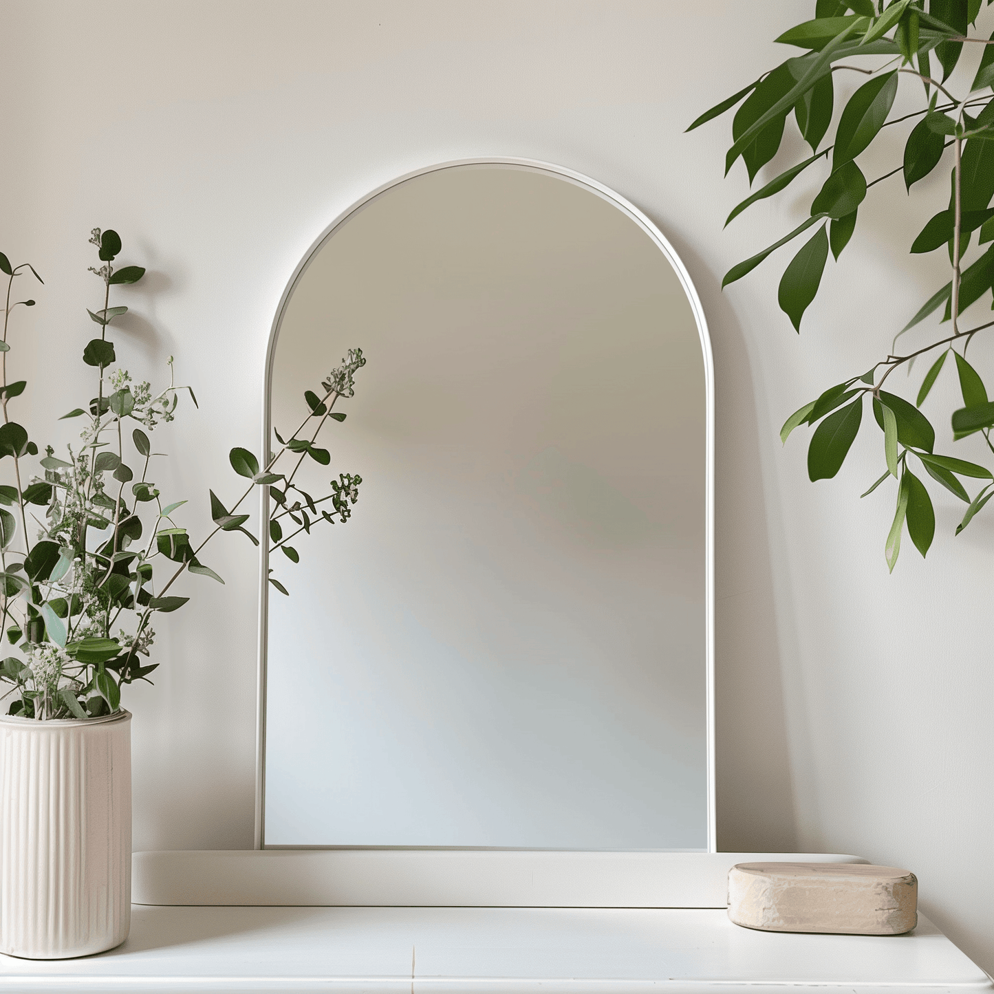 White Arch Aluminium Mirror 60x90 styled with greenery. Brightens up space while blending with natural decor elements.