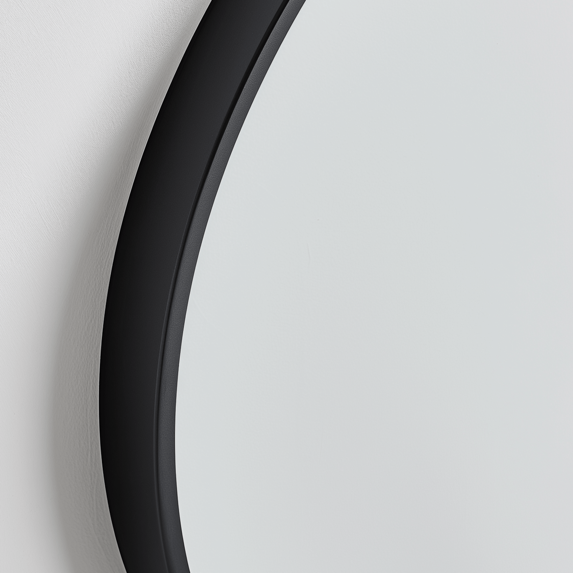 Close-up of Organic 100x88 Duo mirror with matte black frame, highlighting its smooth, curved eco-conscious design.