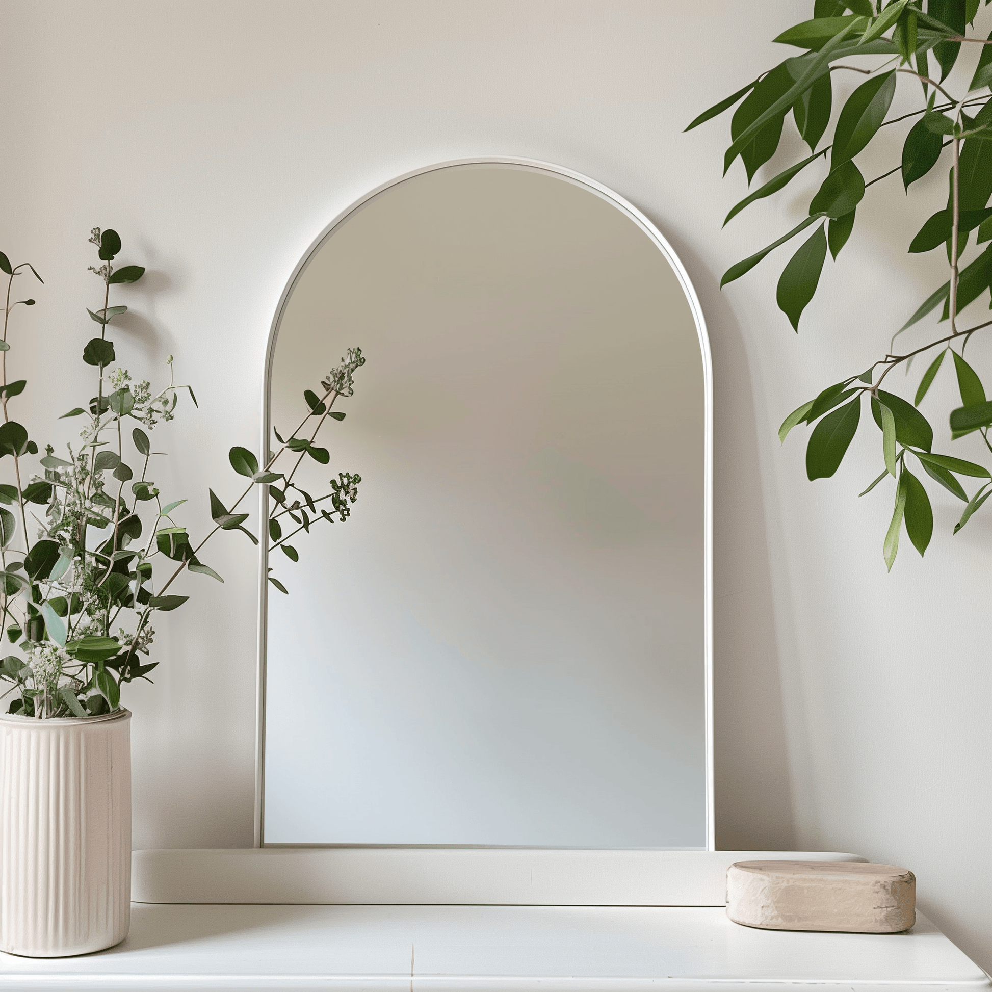 White-framed Arch 70 x 55cm Duo mirror styled with greenery, perfect for brightening up minimalist or Scandinavian-inspired interiors.